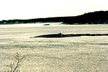 Islet in snow-covered-plane-like water